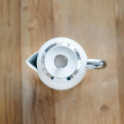 Birds-eye-view photo of a kettle on wooden worktop