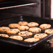 A tray of cookies being taken out of the oven