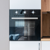 Close-up of an integrated oven in a modern white high gloss kitchen