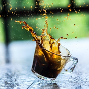 Photo of a coffee cup that has been dropped and is spilling