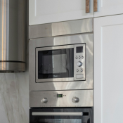 A photo of a built-in microwave in a modern light coloured kitchen