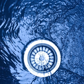 A photo of water draining down a plug hole